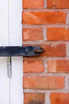Red Brick Wall with part of the window shutter strap Stockfoto's