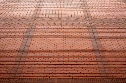 Red brick wall in perspective for background. Stock Photos