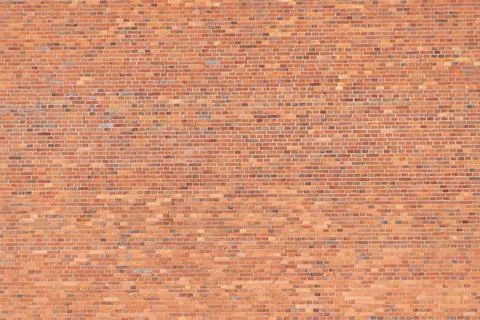 Red brick wall. rough, aged bricks. Backgrounds and textures. Stock Photos