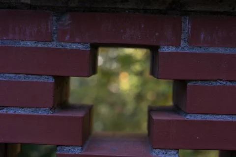 Red brick wall see through with cross and garden background Stock Photos