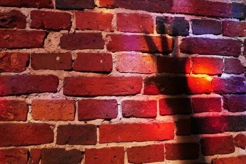 A red brick wall with shadow of a hand Stock Photos