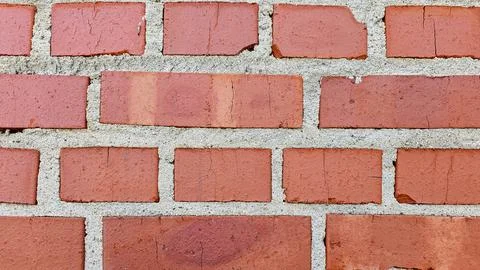 Red brick wall showing a pattern of bricks and mortar as an architectural b.. Stock Photos