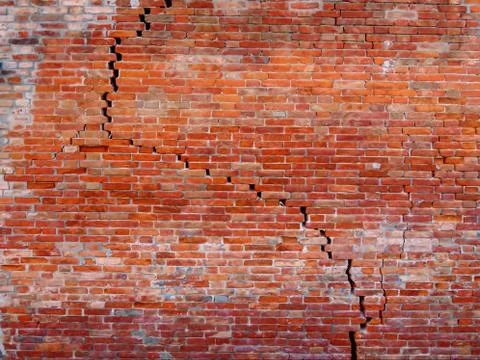 Red brick wall with structural crack Stock Photos