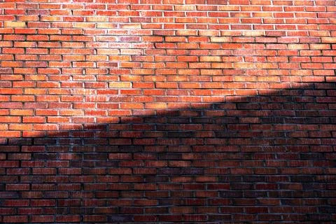Red brick wall texture background, shadow on the wall Fotos Stock
