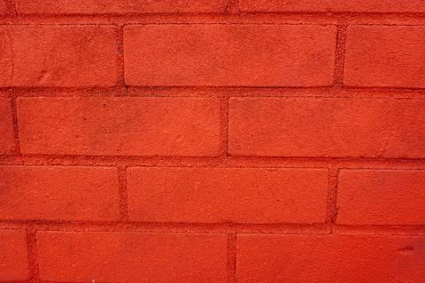 Red brick wall texture. Full frame view of painted brickwork Stockfoto's