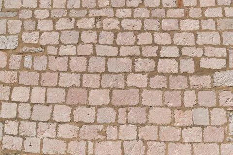 Red brick wall texture with varied sizes and patterns in natural light Stockfoto's