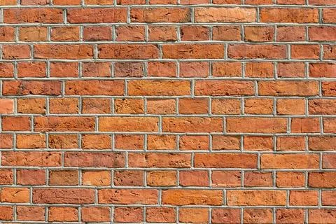 Red brick wall texture with weathered masonry pattern 库存照片