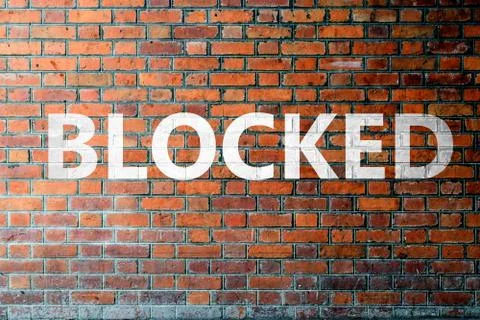 Red Brick wall texture with a word Blocked Foto stock