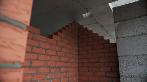 Red brick wall under construction inside building structure Stock Footage 318588211