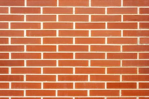 Red brick wall with white plaster seams. Textured background. Stock Photos