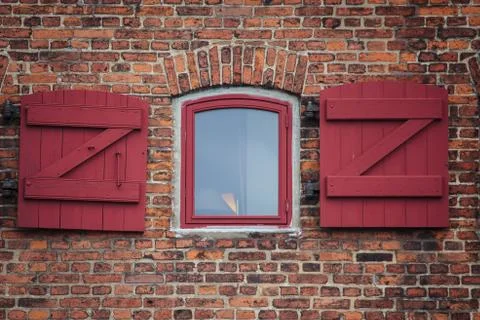Red brick wll with an oldfashioned window Stock Photos