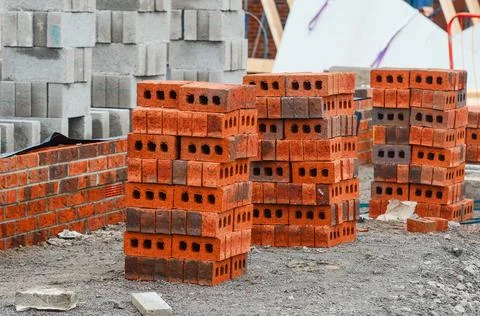 Red bricks and concrete blocks delivered on construction site and placed next 스톡 사진