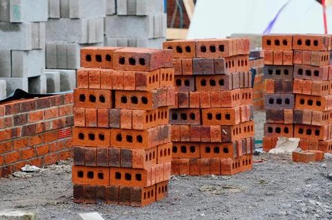 Red bricks and concrete blocks delivered on construction site and placed ne.. Stockfoto's