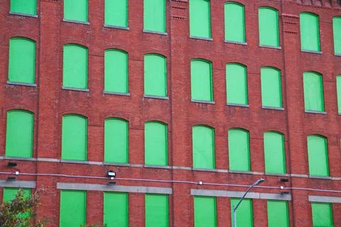 The red bricks and the green windows pattern Stock Photos