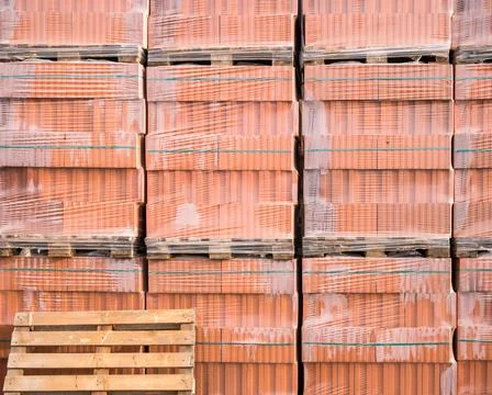 Red bricks for construction buildings stacked on wooden pallets Stock Photos