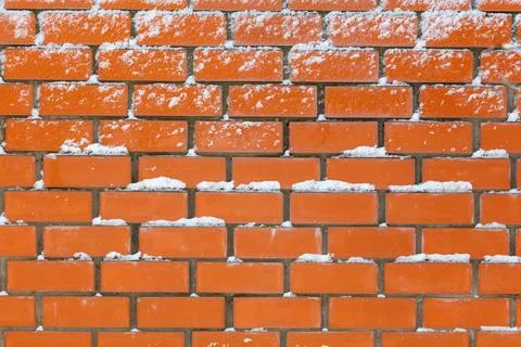 Red bricks covered in light snowfall Stock Photos