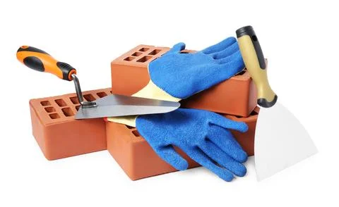 Red bricks, gloves and trowels on white background Stock Photos
