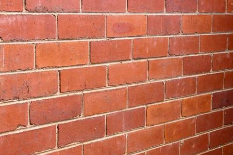 Red bricks joined together with grey mortar Stock Photos