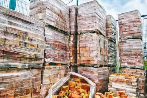 Red bricks on pallets on a construction outdoor store Stock Photos
