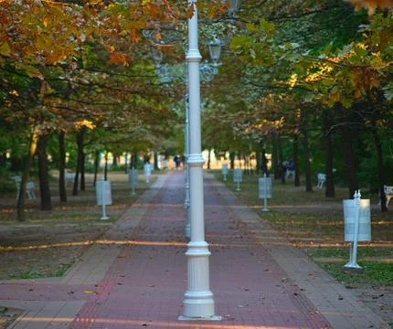 Red bricks pathway with row of lanterns in middle Stock Photos