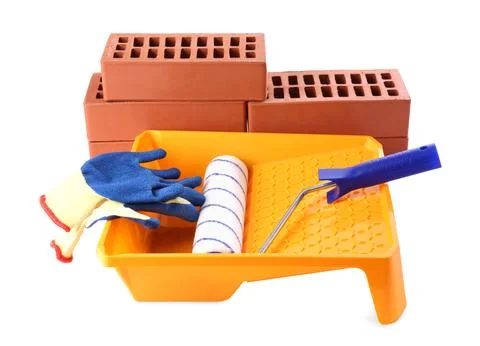 Red bricks, roller, gloves and tray isolated on white. Building material an.. Fotos de archivo