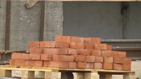 Red bricks stacked at a construction site, close-up. Video stock 196268077