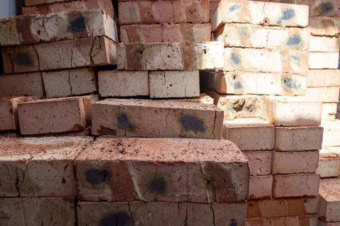 Red bricks stacked on a construction site close-up. Building stone prepared.. Stockfoto's