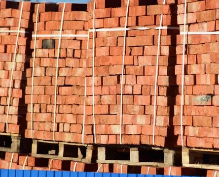 Red bricks stacked into cubes. Warehouse bricks. Storage brickworks products Stockfoto's