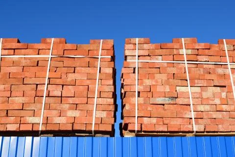 Red bricks stacked into cubes. Warehouse bricks. Storage brickworks products Stock Photos
