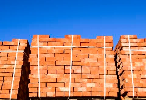 Red bricks stacked into cubes. Warehouse bricks. Storage brickworks products Stockfoto's