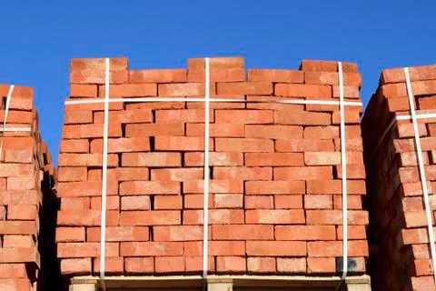 Red bricks stacked into cubes. Warehouse bricks. Storage brickwo Stock Photos