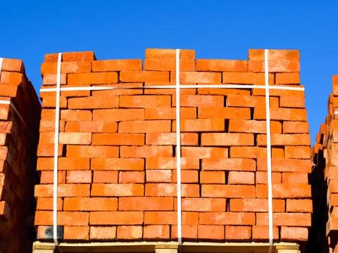 Red bricks stacked into cubes. Warehouse bricks. Storage brickworks products 写真素材