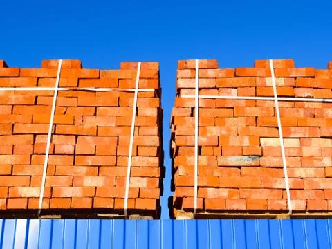 Red bricks stacked into cubes. Warehouse bricks. Storage brickworks products Stock Photos
