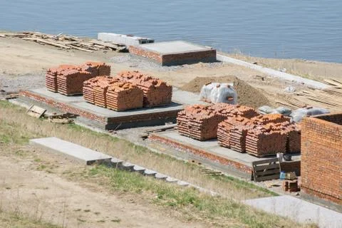 Red bricks stacked in piles at the construction site Stockfoto's