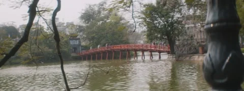Red Bridge Behind Tree and Lamp in Hanoi, Vietnam Stock Footage 310538992