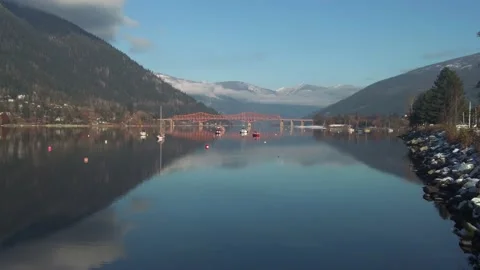 Red bridge crosses a river Stock Footage 222025613