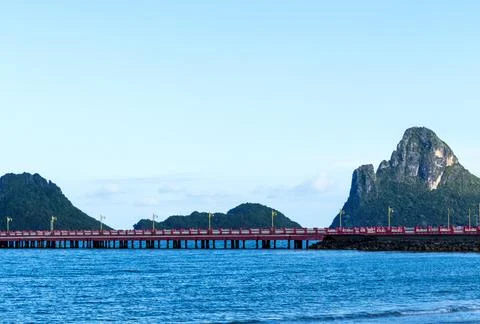 Red Bridge That Extends To The Sea Stock Photos