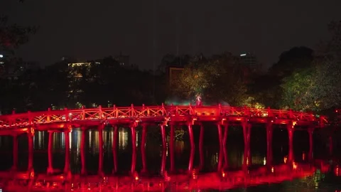 Red bridge illuminated during night performance at Hoan Kiem Lake, Hanoi Stock Footage 330050442