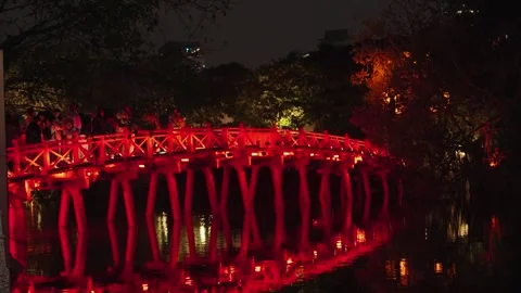 Red bridge illuminated during night performance at Hoan Kiem Lake, Hanoi Stock Footage 330050663