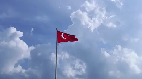Red bright flag of Turkey flutters on a flagpole high above the ground against Stock Footage 246519909