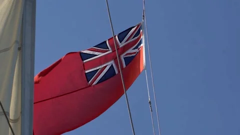Red British Ensign flag blowing in the wind on board as tall ship sailing. Stock Footage 131340350