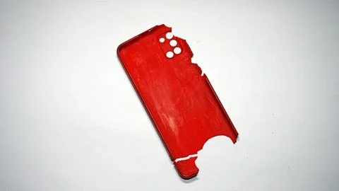 Red Broken Smartphone Case on White Background Close-Up Stock Photos