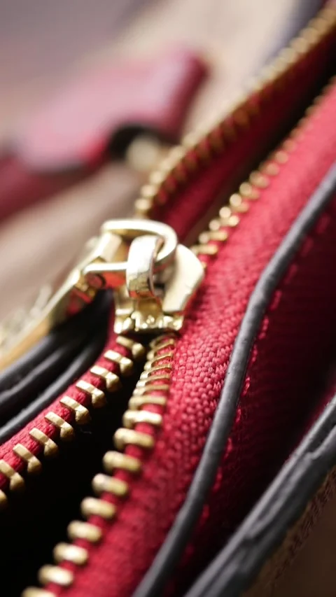 Red broken zipper on a bag shows its details clearly 스톡 동영상 336355465