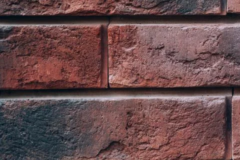 Red-brown brick wall, textured background. Weathered concrete Stock Photos