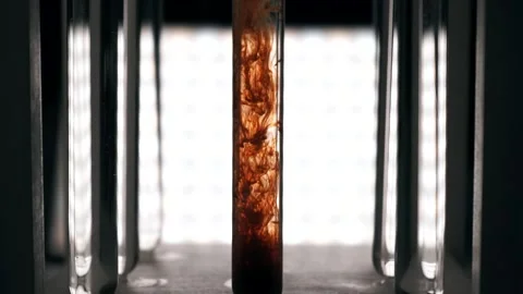 Red-brown ink drop in water, drop color mixture falls on water. Slow motion Stock Footage 188749500