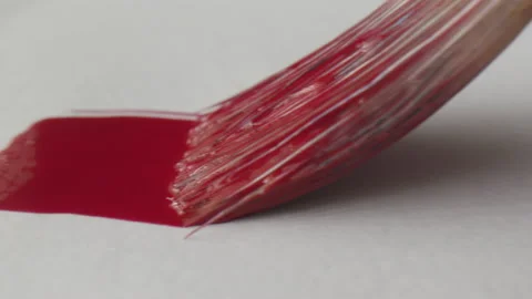 Red brush stroke painted on white paper Stock Footage 134797635