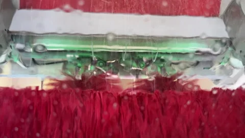Red Brushes Cleaning Car Windshield in Automatic Car Wash Stock Footage 333050981