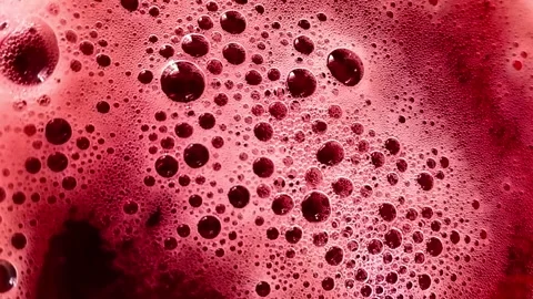 Red bubbles of frothy drink. Stock Footage 244176682