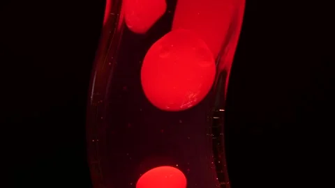 Red bubbles moving in a lava lamp Stock Footage 251640776