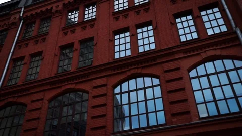 A red building with a chimney with cloudy sky. Footage. Bottom view of the Stock Footage 129032194